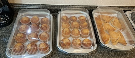 Three trays of baked goods on a countertop.