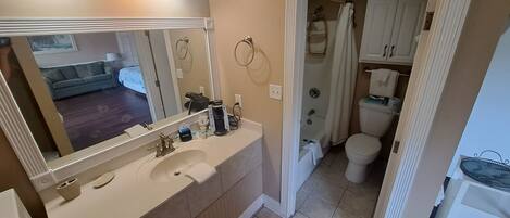 A bathroom with a sink, mirror, and toilet.