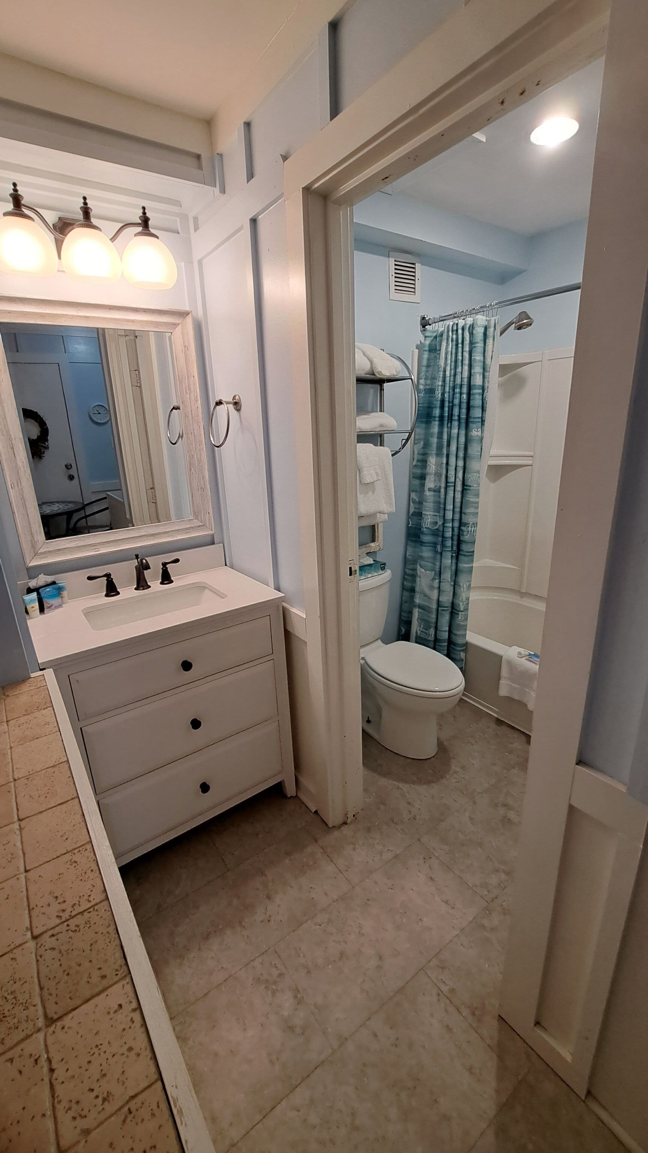 A bathroom with a sink, mirror, and toilet.