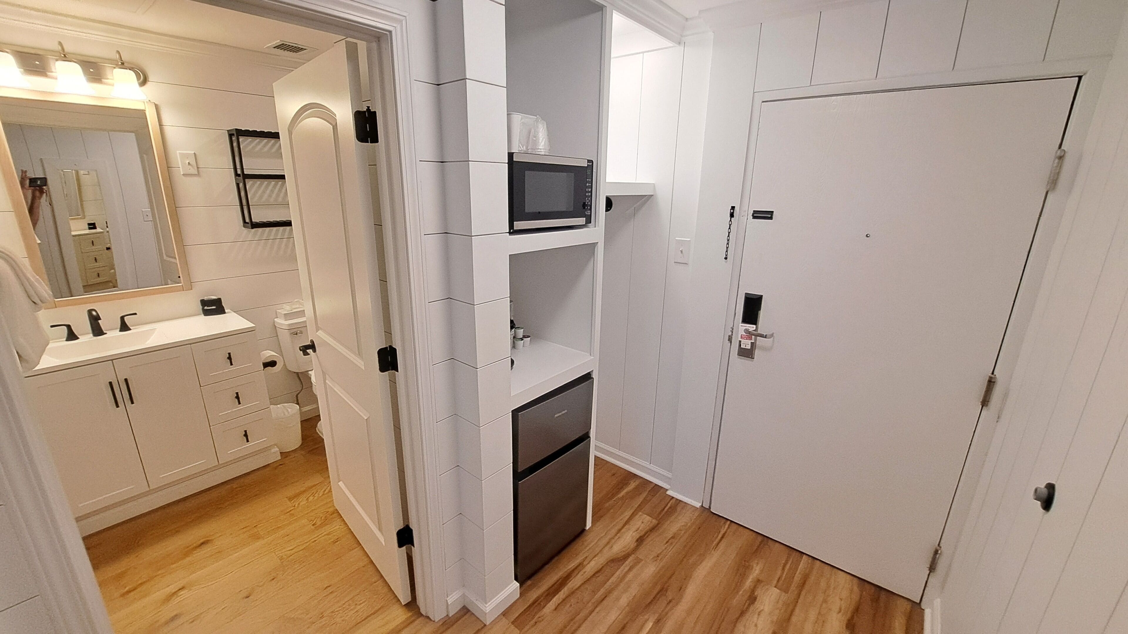 A bathroom with a sink, mirror, and storage cabinets.