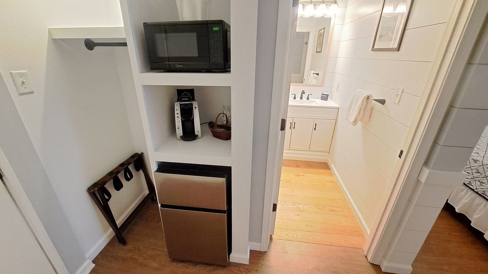 A compact kitchen with a microwave, coffee maker, and a small refrigerator.