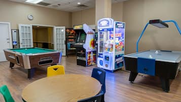 Enjoy games and entertainment in this lively indoor space with a pool table, dartboard, and claw machine.