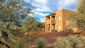 A two-story building with a flat roof and a balcony on the second floor. - WorldMark Rancho Vistoso (Oro Valley)