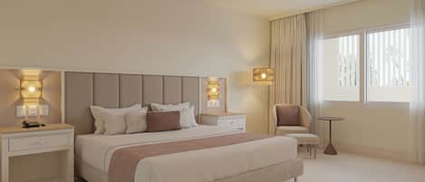 A modern hotel room with a large bed, bedside tables, a chair, and a small table.