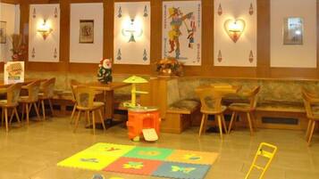 Relax in the inviting lobby area, featuring a reception desk, comfortable seating, and colorful artwork.
