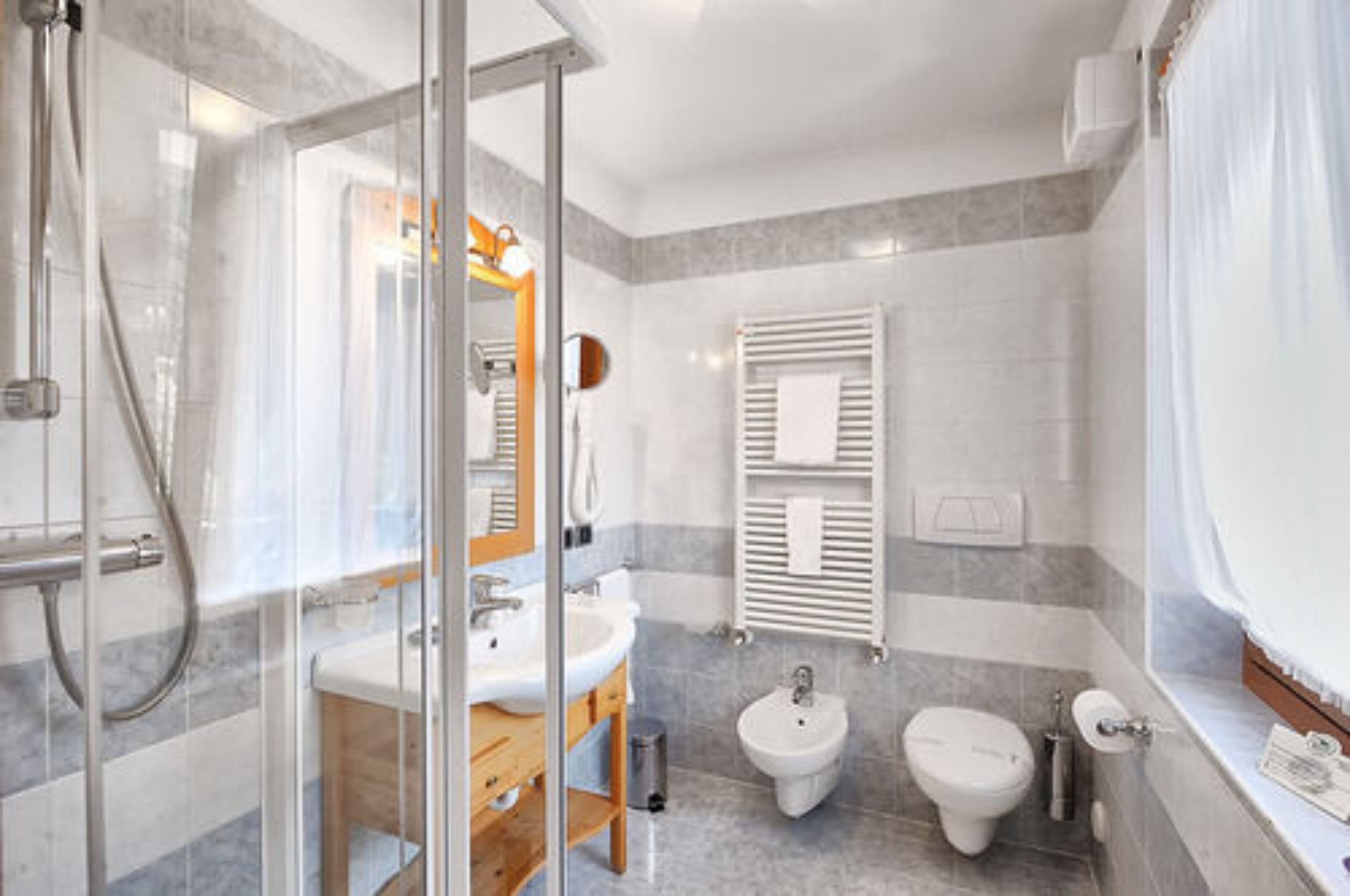 combined shower/bathtub, designer toiletries, hair dryer, bathrobes