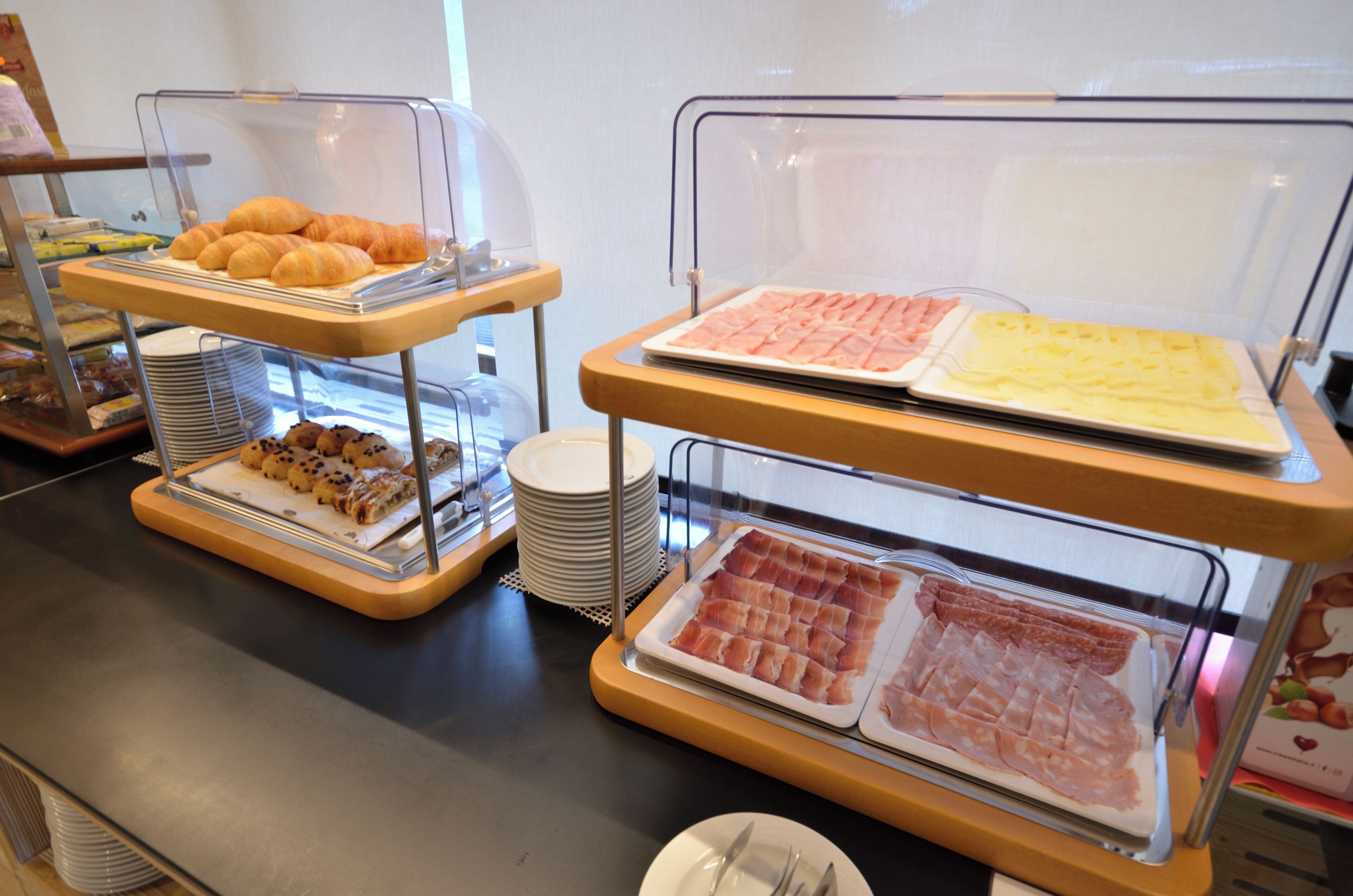 A buffet with various food items displayed in clear containers.