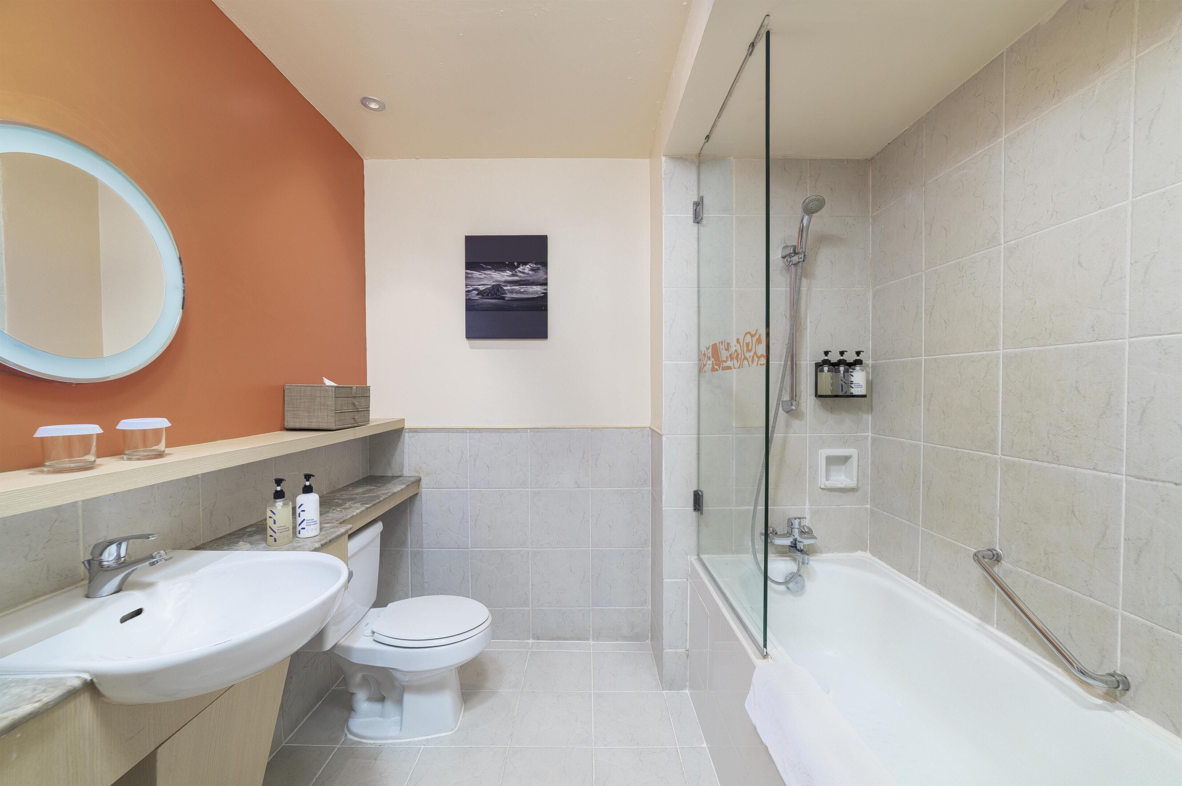 A bathroom with a sink, toilet, and bathtub.