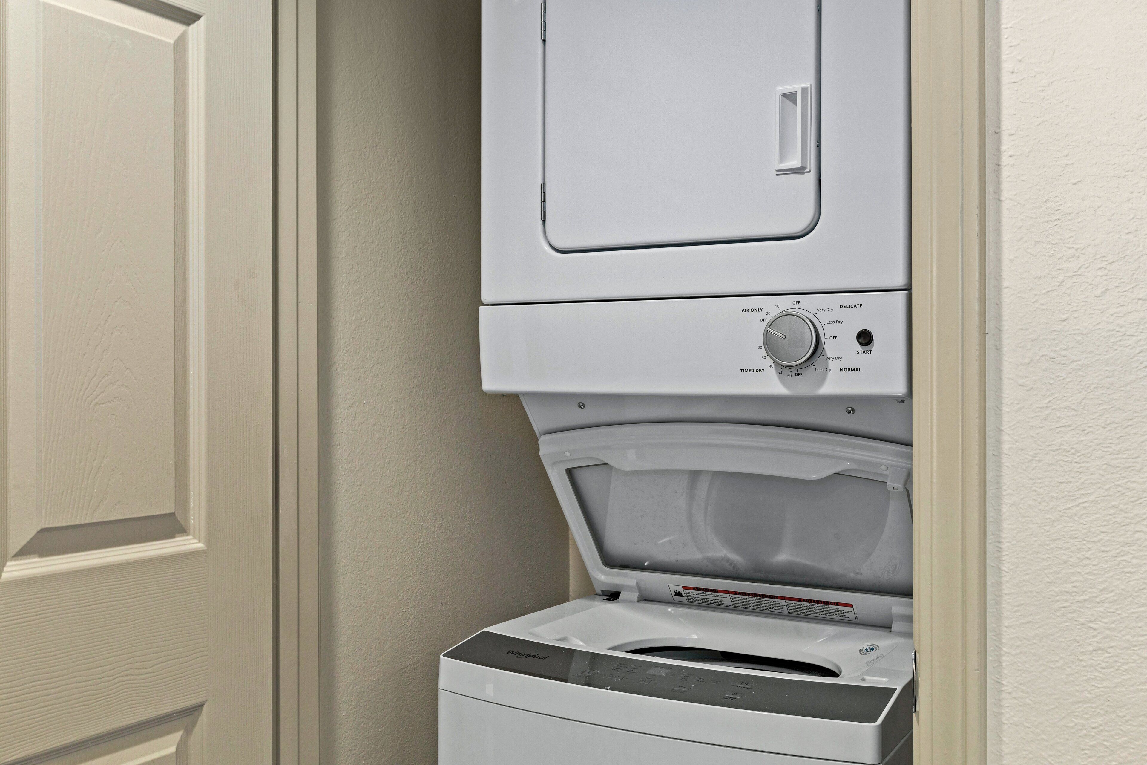 A front-loading washer and dryer unit with a control panel and a door.