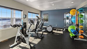 A gym with various exercise equipment, large windows, and a view of the outdoors. - WorldMark Lake of the Ozarks (Osage Beach)