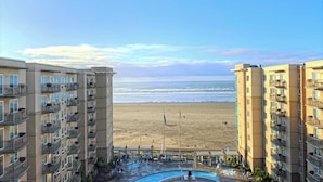 A beachfront hotel with multiple balconies, a swimming pool, and a view of the ocean. - Resort at Seaside (Seaside)