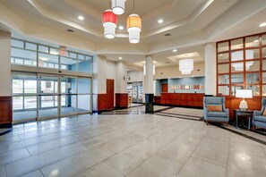 A spacious lobby with a reception desk, seating area, and a glass entrance. - Drury Inn & Suites Montgomery (Montgomery)