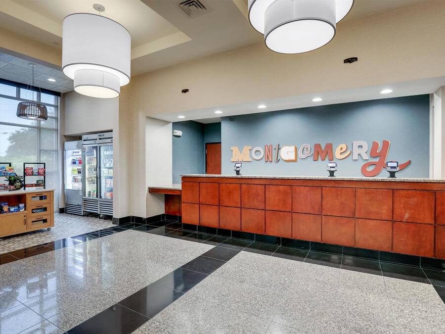 A reception area with a counter, a wooden cabinet, and a large window.
