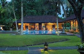 A resort with a swimming pool, surrounded by tropical vegetation and a well-maintained lawn. - Tanah Gajah, a Resort by Hadiprana (Ubud)