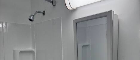 A modern bathroom with a bathtub, a sink, and a mirror.