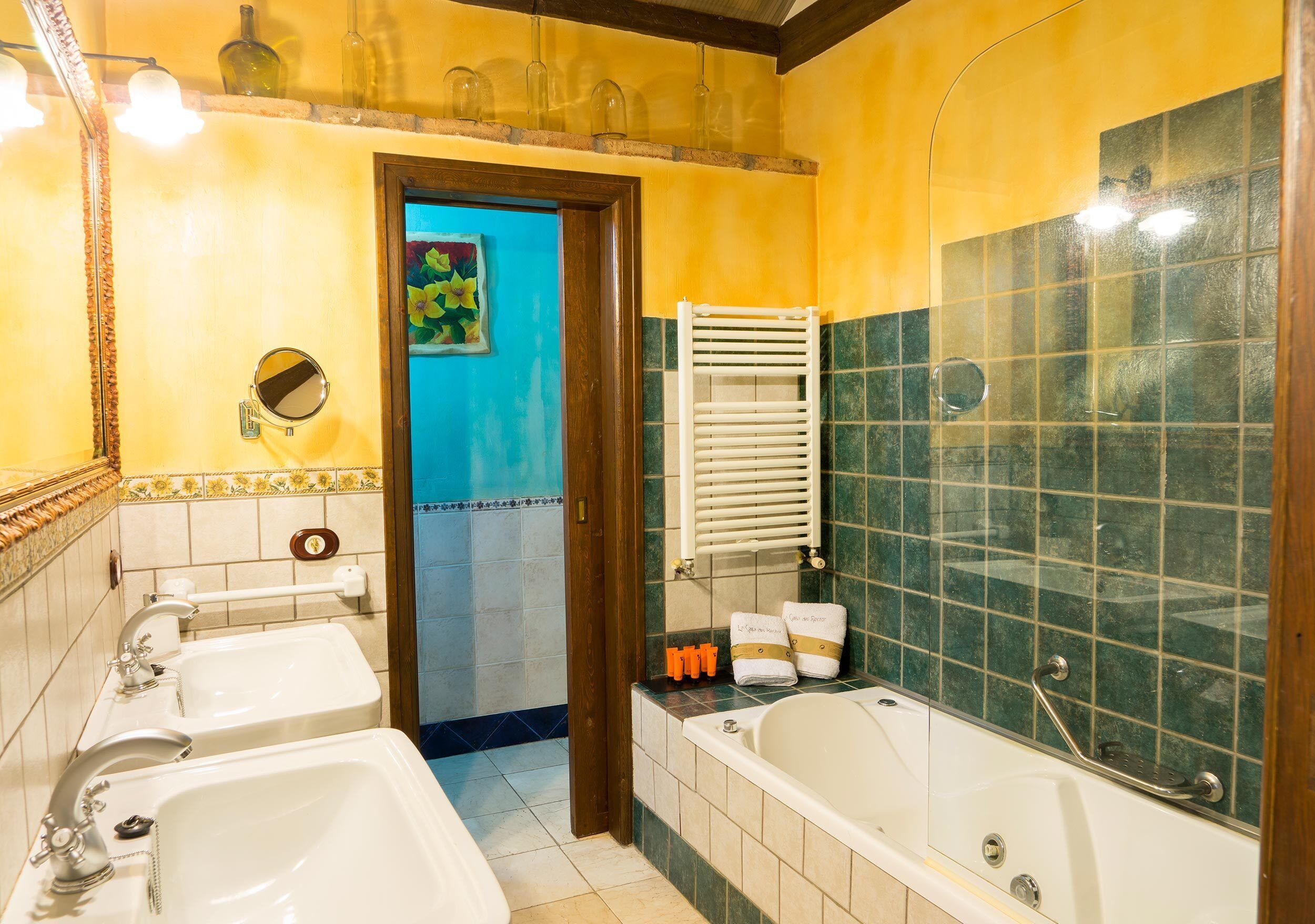 A bathroom with two sinks, a bathtub, and a shower area.