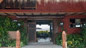 A building entrance with a sign reading "AURA DELMAR." - Hotel Aura del Mar (Zihuatanejo)