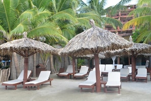 On the beach, sun-loungers, beach umbrellas, beach towels