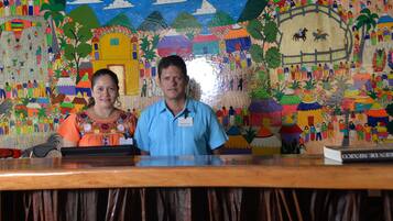 Welcome to the vibrant reception area, featuring a colorful mural and a welcoming counter.
