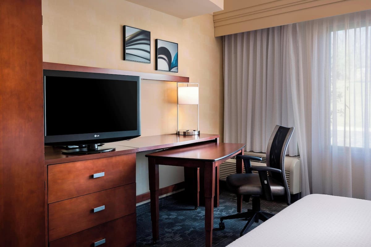 Premium bedding, desk, laptop workspace, blackout curtains