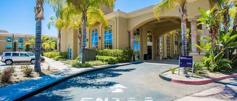 A hotel entrance with a clear path marked 'ENTER' leading to the building.