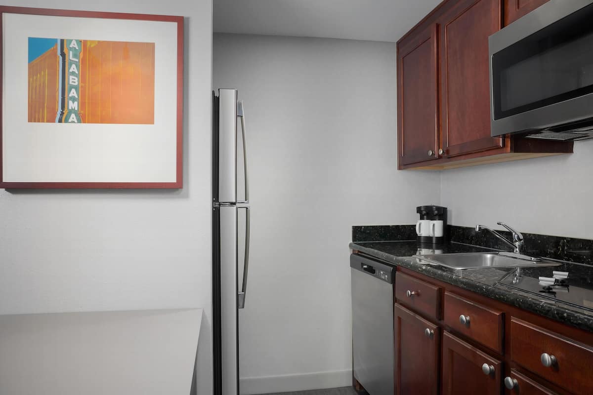 full-sized fridge, microwave, stovetop, dishwasher