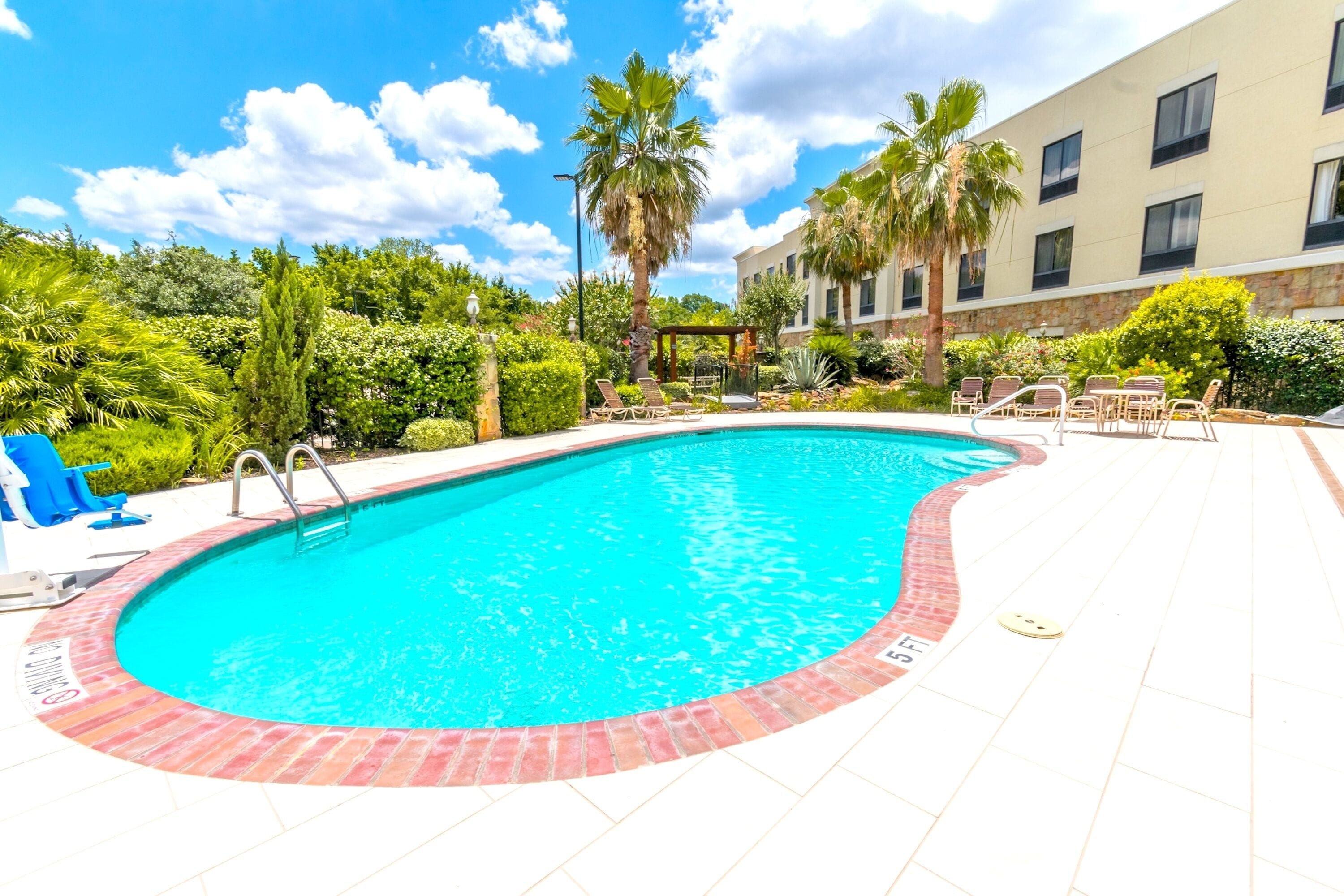 Outdoor pool, open 7 AM to 11 PM, pool loungers