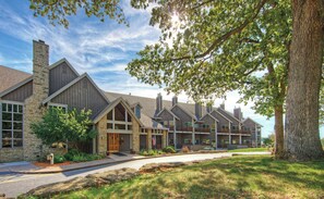 A multi-story building with a stone facade, large windows, and a prominent American flag. - WorldMark Galena (Hanover)