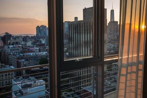 A cityscape view from a high-rise building with a window reflecting the skyline.