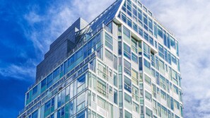 A modern glass building with a clear sky in the background.