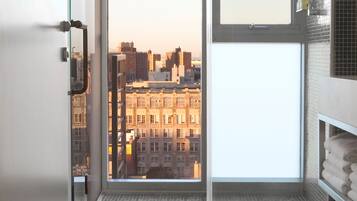 Shower, designer toiletries, hair dryer, towels