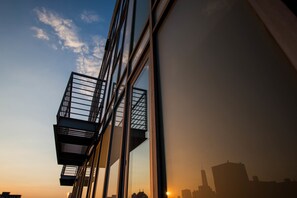 A modern building with large windows and a balcony.