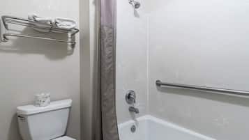 A bathroom with a toilet, a towel rack, a shower with a grab bar, and a toilet paper holder.