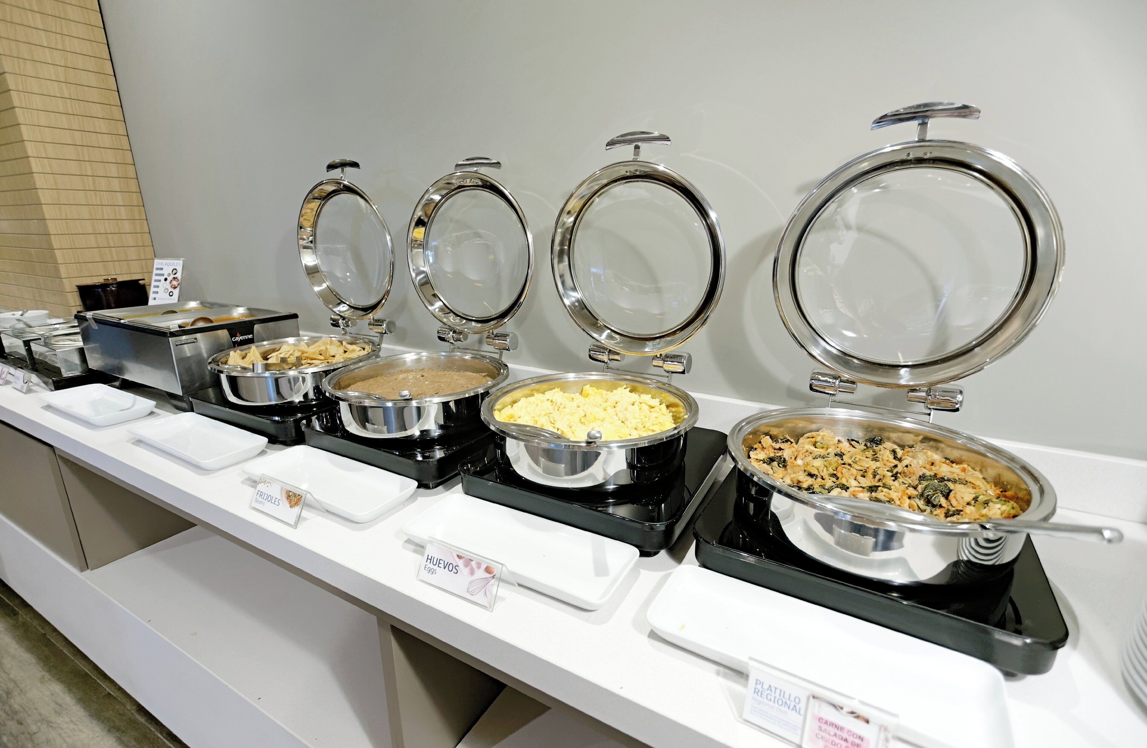 A buffet line with various food items.