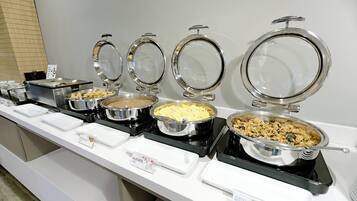 A buffet line with various food items.