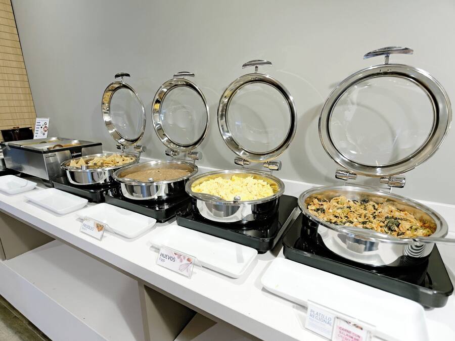 A buffet line with various food items.