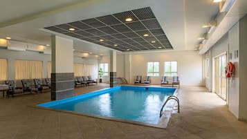 Indoor pool, open 9:00 AM to 9:00 PM, pool loungers