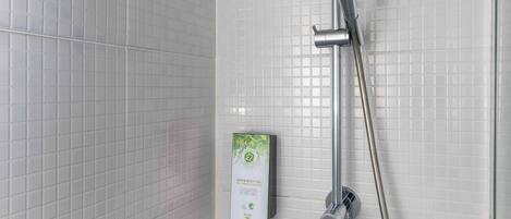 A shower with a handheld showerhead and a wall-mounted rain showerhead.