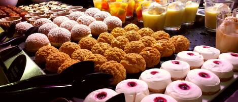 A variety of desserts and beverages on display.