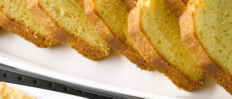 A tray of golden-brown bread slices and a stack of thin, crispy crackers.