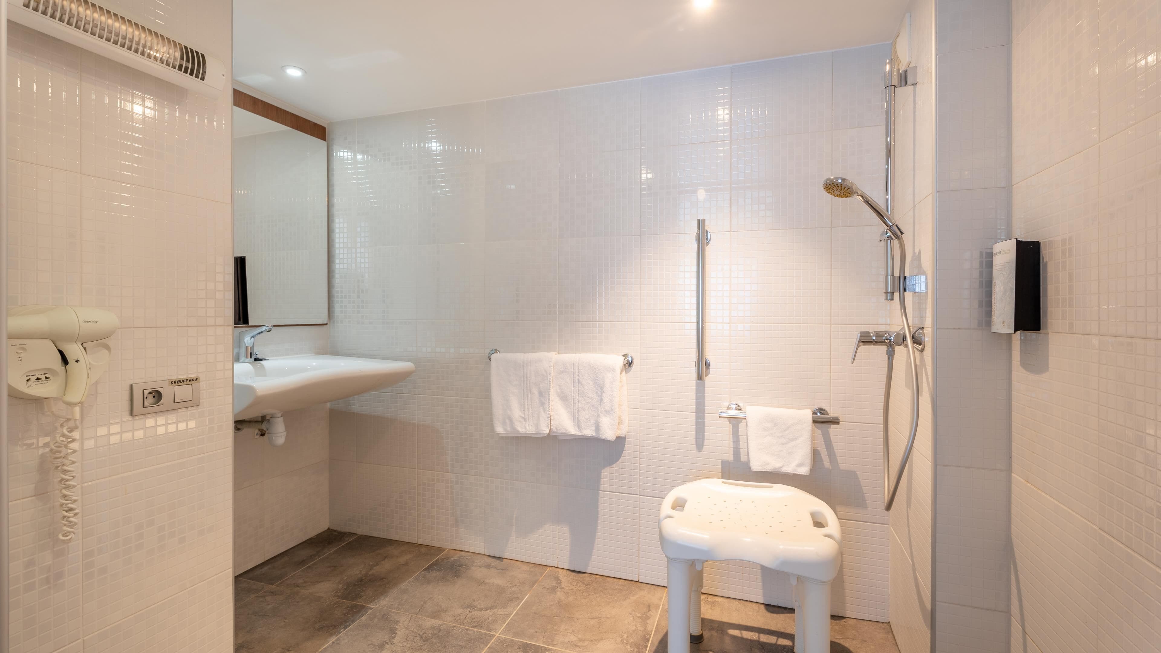 Une salle de bain moderne équipée d’une douche, d’un lavabo et de toilettes.