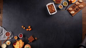 A variety of desserts and pastries on a dark slate table, including a pie, bread with cream, and a pineapple. - Hotel Campanile Nantes Ouest - Saint Herblain (Saint-Herblain)