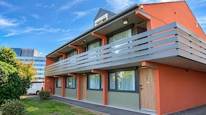 A modern building with a flat roof, large windows, and a balcony. - Campanile NATURE - Nantes Ouest Saint Herblain (Saint-Herblain)