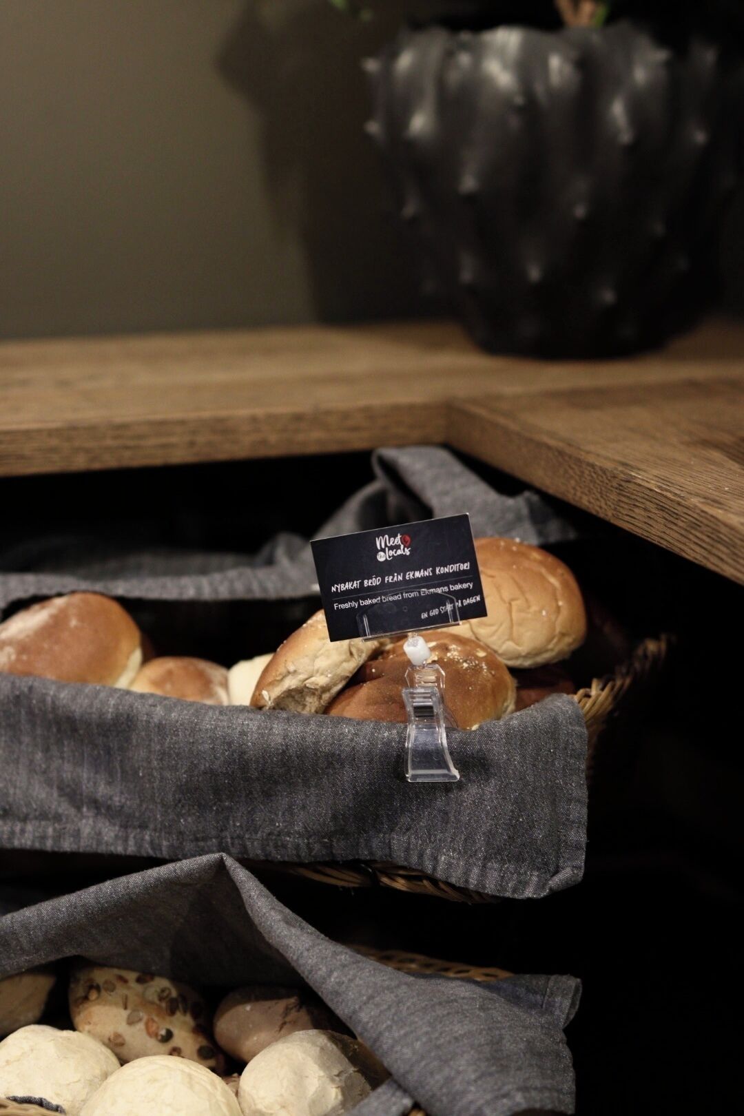 A basket of bread and pastries with a label.