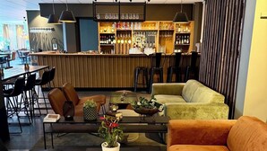 A modern lounge area with a bar, seating arrangements, and a reception desk. - Best Western Hotel Trollhattan (Trollhattan)