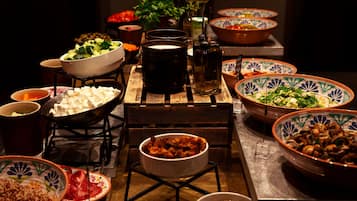 A table with various dishes and a candle.