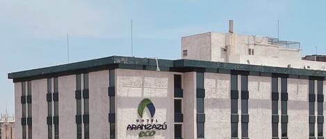 A modern building with a sign for 'Hotel Aranzazu Eco'.
