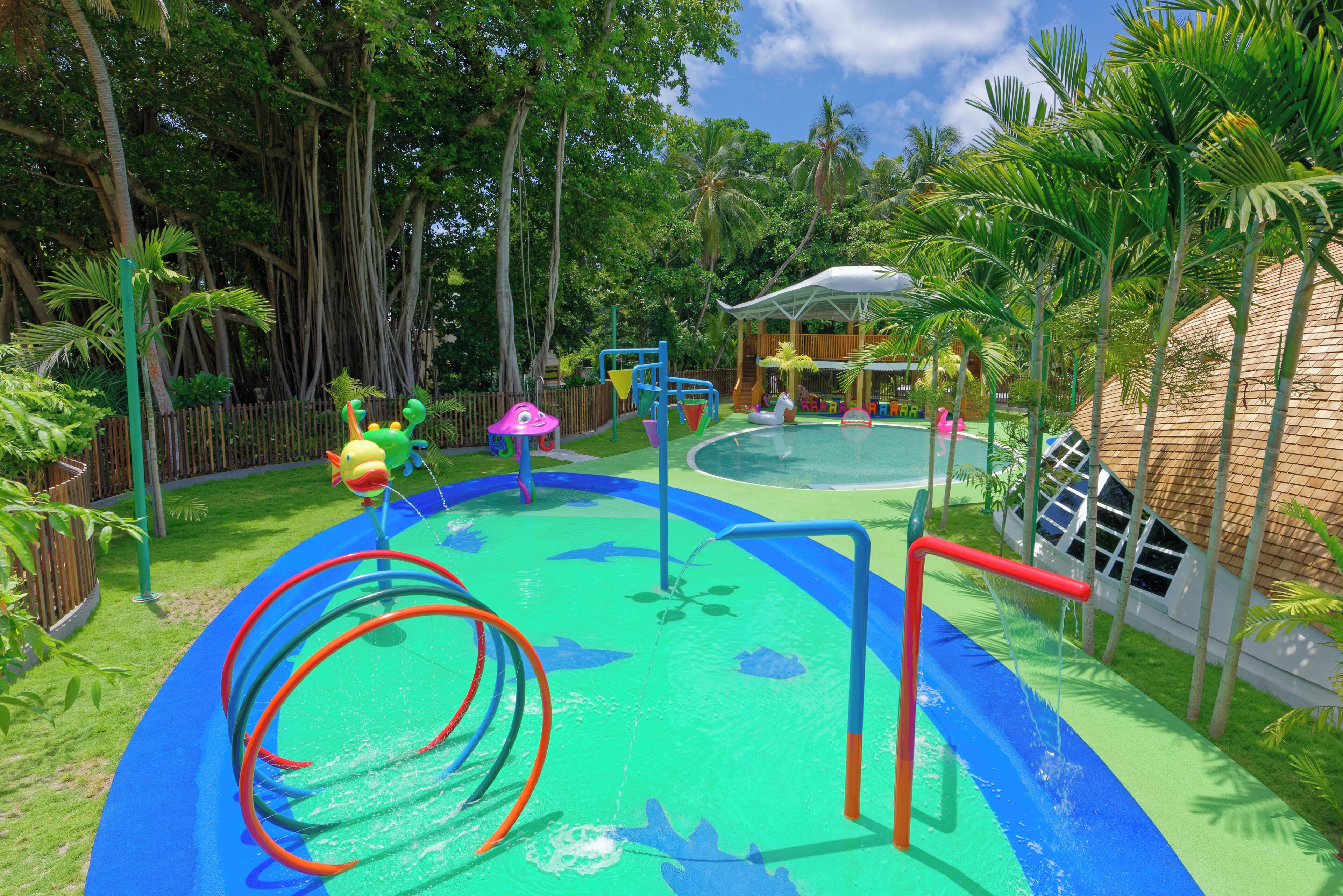 A water park with slides, a pool, and play structures.
