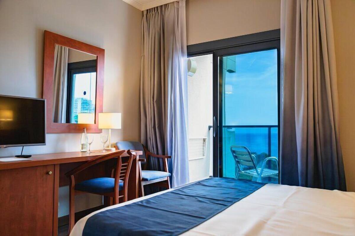 Minibar, desk, bed sheets