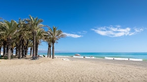 A beach with palm trees and a clear blue sky. - Hotel Costa Málaga (Adults Recommended) by Pierre & Vacances (Torremolinos)